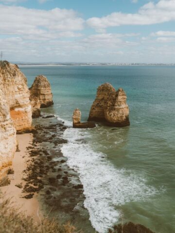 Big orange cliffs in lagos with bright blue ocean