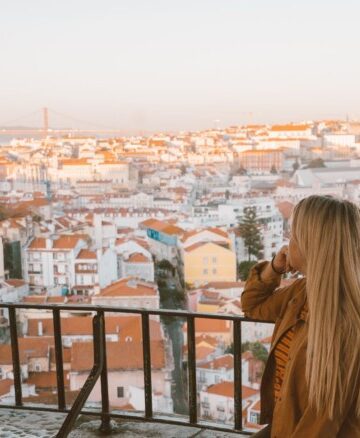 girl looking out at miradouros and rooftops in Lisbon