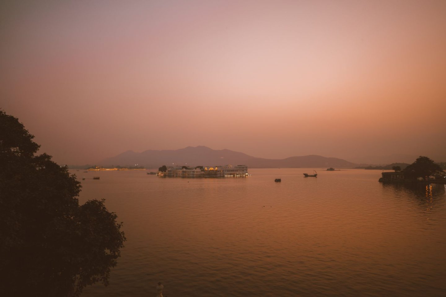 sunset in Udaipur with view of a floating palace
